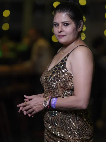 A glittering gold and black sequin dress for a launch party. The intricate pattern and sleek silhouette make it a perfect choice for a night out.