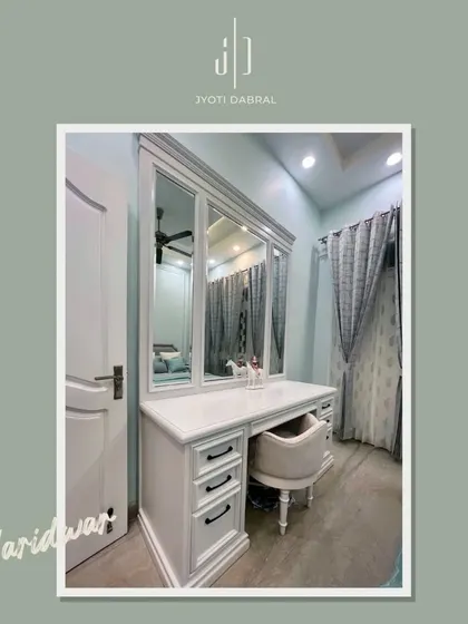 A classic white dressing table with a three-panel mirror and elegant detailing. This piece provides ample storage and a dedicated space for getting ready, adding a touch of luxury to the bedroom.