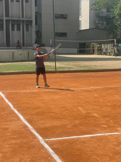 A player hitting a forehand during a practice match. The intensity of these sessions prepares them for official tournaments.