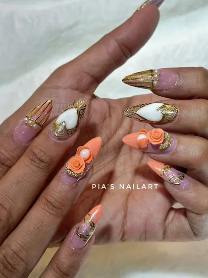 A luxurious set featuring hand-sculpted 3D orange roses, gold chrome details, and pearl accents. This is wearable art.