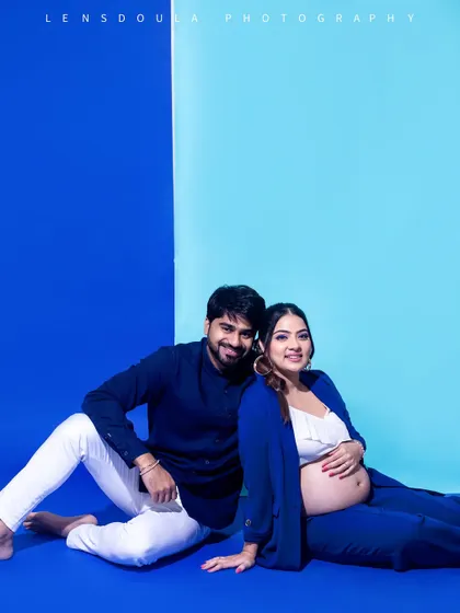 A comfortable and intimate floor pose. The shades of blue create a cool and calming atmosphere for this modern maternity portrait.