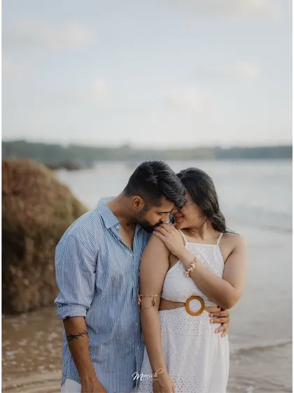 An intimate embrace on the shores of Goa, the soft light of dusk creating a perfectly romantic atmosphere.