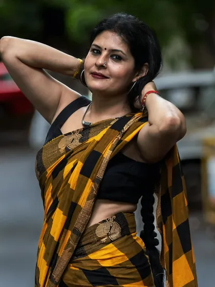 A confident pose in the yellow and black Kanchi cotton saree. I help clients find poses and angles that make them feel their best in their clothes.