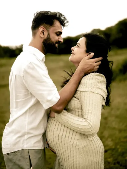 An intimate portrait of the couple embracing. He gently holds her face as they look at each other, a moment filled with tenderness and love.