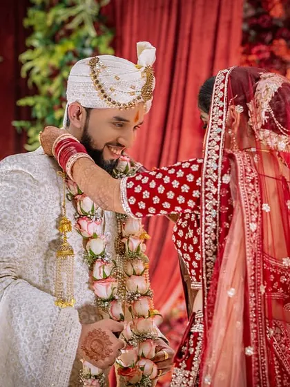The bride places the garland on the groom, a playful and happy moment from the Varmala ceremony.