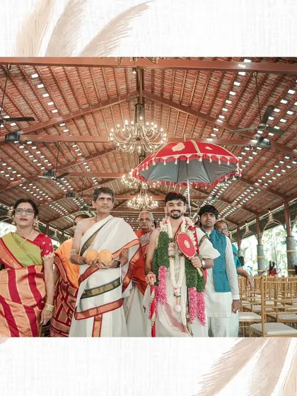 The groom's grand entrance, or Kashi Yatra, at a traditional South Indian wedding, surrounded by family and holding a ceremonial umbrella.