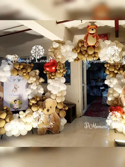 The entrance to the teddy bear party, featuring a circular balloon arch and cute teddy bear cutouts to welcome guests.
