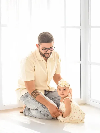 A father's gentle love for his daughter. These quiet, tender moments are just as important to capture as the big smiles.