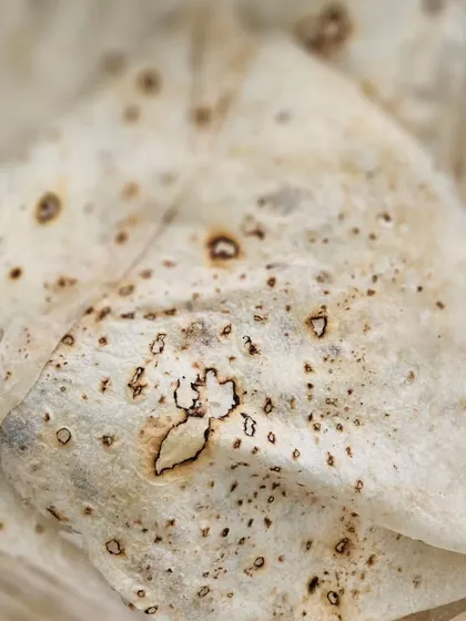 Soft, folded phulkas or rotis, ready to be served with our variety of vegetarian curries.