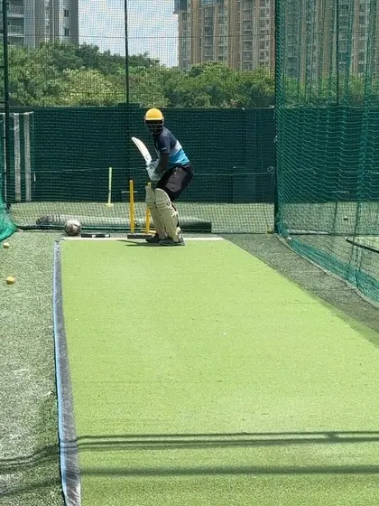 A close-up of the batsman's stance, ready to face the ball. A stable base is key.