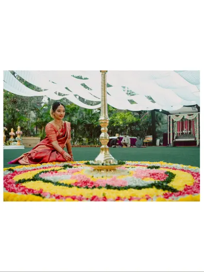 A wide shot showing the beautiful floral rangoli and decor of a South Indian wedding ceremony.