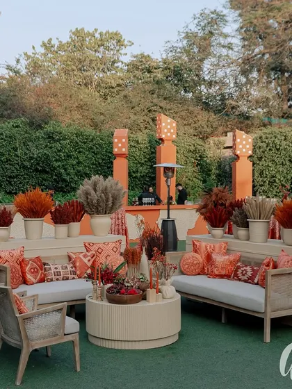 This outdoor lounge area was designed with warm red and orange tones. We used dried grasses and floral arrangements to define the space, set against a backdrop of dramatic stage lighting for the evening's performances.