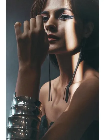 A beauty shot taken with the Sigma 30mm lens. The lens's sharpness is evident in the crisp details of the makeup and the texture of the accessories.