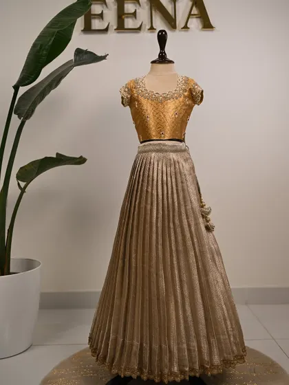 My super energetic baby client Smaya looks absolutely adorable in her customized tissue lehenga. I designed this golden outfit with a beautiful hand-embroidered blouse featuring pearl and stone work around the neckline.