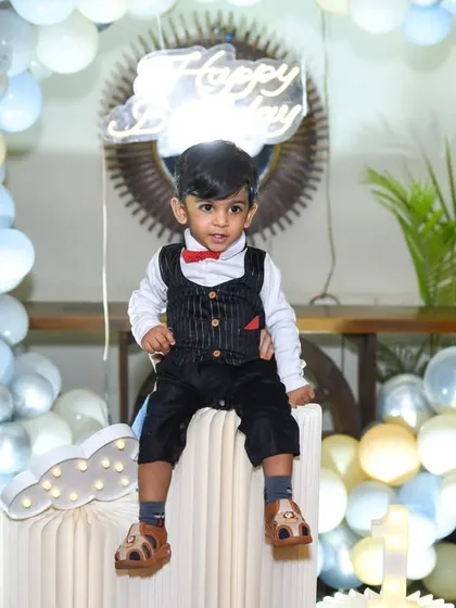 A cool portrait of the birthday boy looking dapper in his vest and bow tie. We take time to capture individual portraits of the star of the day.