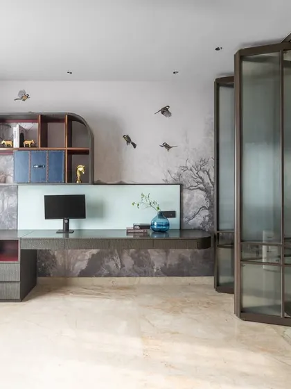 A wide view of the sophisticated yet playful home office and study space. The design features a scenic wallpaper, a sleek floating desk, and custom shelving, creating a space suitable for all ages.