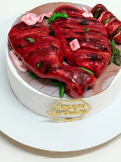 Believe it or not, this is a cake! I designed this to look like a plate of tandoori chicken for a client who wanted a truly unique and surprising birthday cake. Everything you see is completely edible.