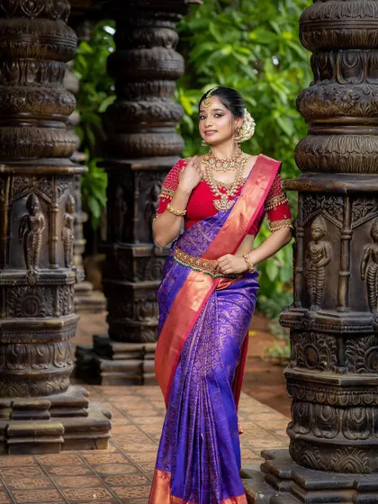 A full-length shot showing how this temple jewellery set pairs with a vibrant purple and red Kanjeevaram saree.