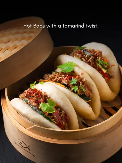 We explore global flavors to create unique menus for our clients. These hot baos with a tamarind twist, served in traditional bamboo steamers, are an example of our modern take on Asian cuisine, perfect for adding an element of surprise to your event.