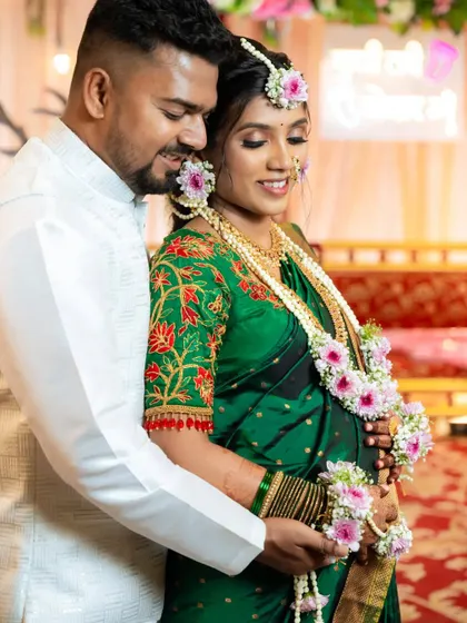 A beautiful moment between the happy couple at their baby shower, with the mom-to-be's intricate mehendi adding to her glow.