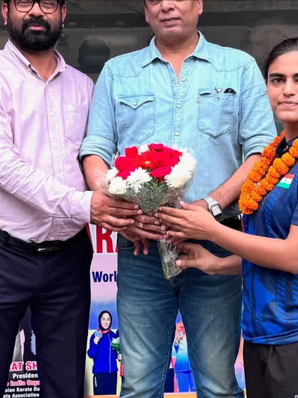 Presenting flowers as a token of good luck to a team member before her departure for the international competition.