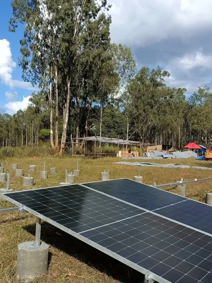 The beginning of our ground-mount solar installation for the Echoes of Earth festival. This image shows the concrete pedestals and initial panel setup for the 20kW system that powered the Big Tree Stage.