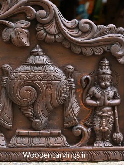A detail of the 48-inch Narayanar panel, showing Hanuman in a posture of devotion, carved with a rich, antique finish.