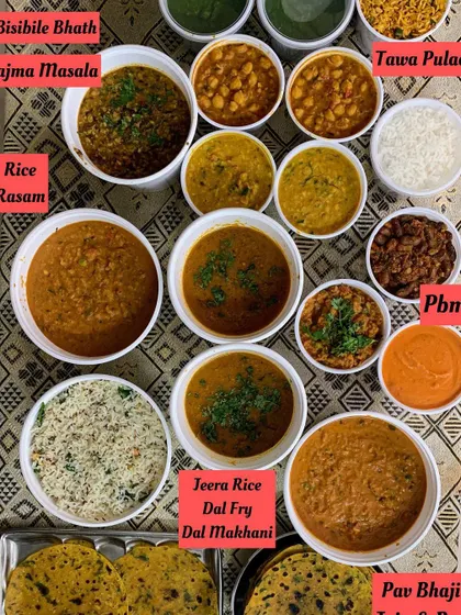 A full view of the diverse main course dishes, ready to be served at a large gathering.