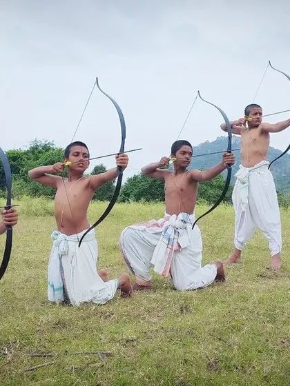Children attain competence through Dhanurvidya. Here, young students demonstrate various archery stances, from sitting to standing, showing the versatility and discipline instilled from an early age.