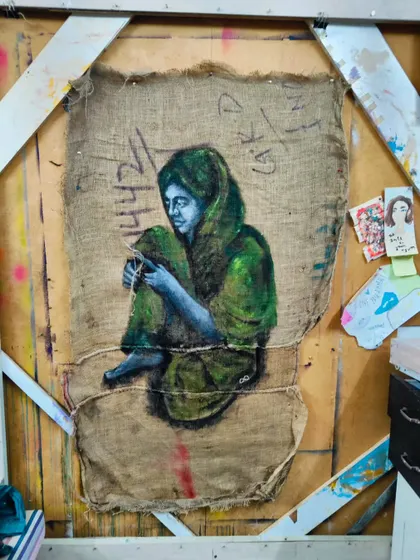 The materials I use are part of the story. This piece, "Mending," is painted with acrylics on a repurposed jute bag. For me, the act of mending the rough, humble fabric is a metaphor for mending our world with compassion. It’s about finding beauty and meaning in unexpected places.