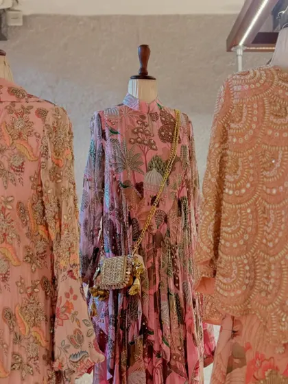 A trio of pretty pink prints. This display showcases different silhouettes, from a floral printed anarkali to a heavily embellished jacket, all in soft, romantic hues.
