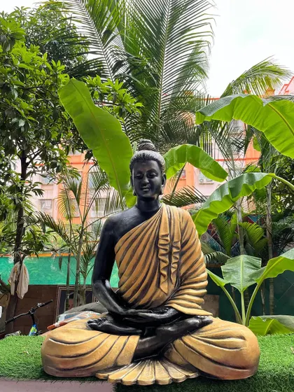 This view of the garden Buddha sculpture shows its calm, meditative posture. It is designed to be a focal point for tranquility in any outdoor or large indoor area.