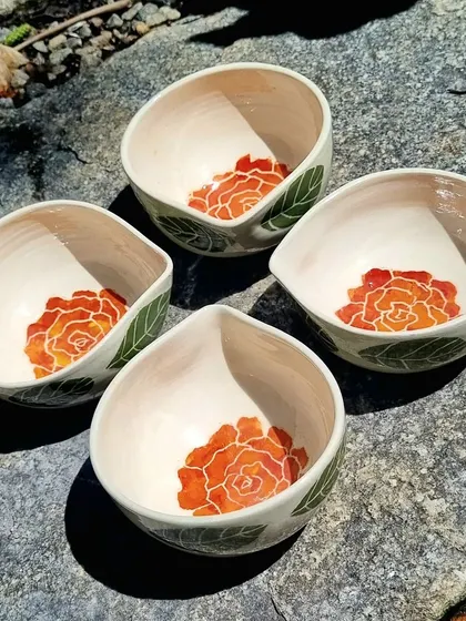 I designed these large, hand painted ceramic bowls to be used as diyas, perfect for festivals like Diwali or as unique decorative bowls. The interior features a hand painted rose, adding a beautiful detail when lit or used for serving. These are available in limited numbers and make for a thoughtful handmade gift.