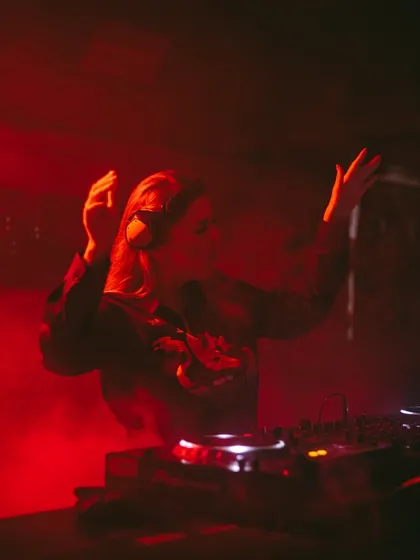 Hands up, lost in the music and red smoke. This is me at my most expressive during a high-energy techno set.