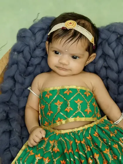 This little Radha decided to stay awake for her shoot, giving us this adorable and slightly curious look.