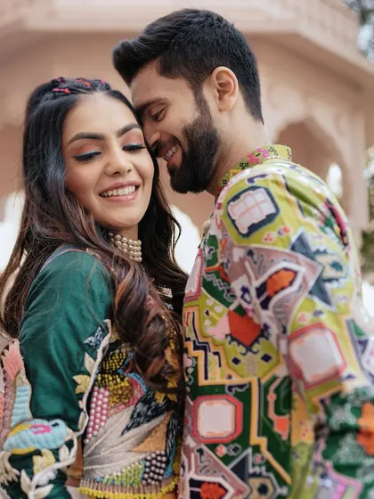 A close-up, romantic shot of the couple at their Haldi, their smiles reflecting the joy and vibrancy of the celebration.