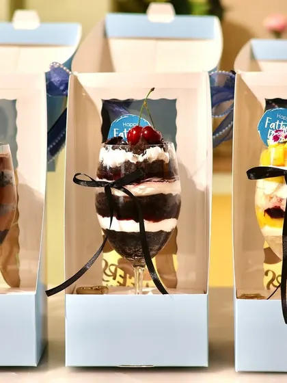 Another view of the packaged 'Cake in a Glass' desserts, showing the 'Happy Father's Day' tags.