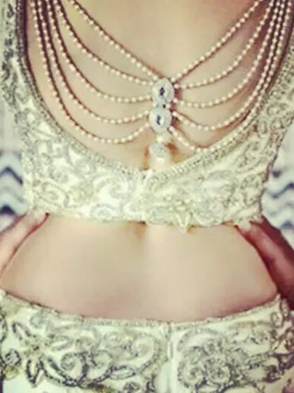 This blouse features a unique back design with pearl chains, perfect for a glamorous party or reception look. I can create custom embellishments based on your ideas.