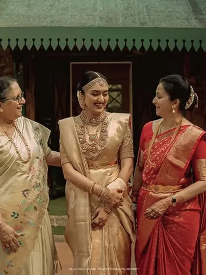 A precious moment between three generations. The bride sharing a smile with her mother and grandmother is a beautiful story of family and love.
