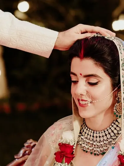 The groom applies sindoor to the bride's forehead, one of the most sacred moments of a Hindu wedding.