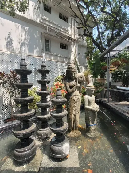 Water is a key sensory element in the design. This feature combines traditional stone sculptures with the gentle sound of flowing water, creating a tranquil focal point within the bustling retail environment.