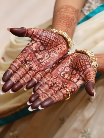 A perfect showcase of the final henna stain. The deep, rich color on the palms is a sign of high-quality, natural henna and proper aftercare.