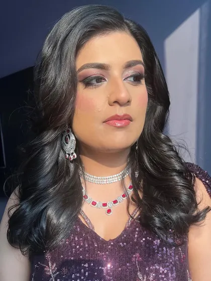 A side profile showing the beautiful blend of colors in her eye makeup.