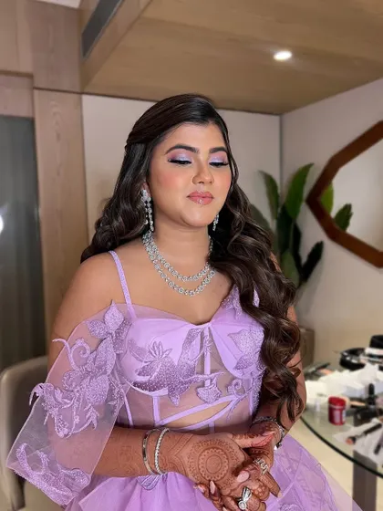 A close up with her eyes closed, showing the soft purple and pink tones on her eyelids.