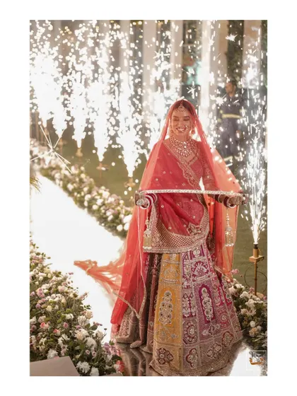 The bride's spectacular entry surrounded by sparklers, creating a magical moment.