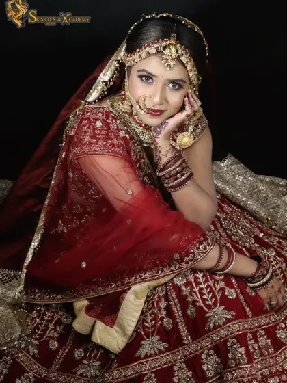 A portrait of pure bridal elegance. The rich red and gold outfit is complemented by a warm, glowing makeup look, making her look like a true queen.