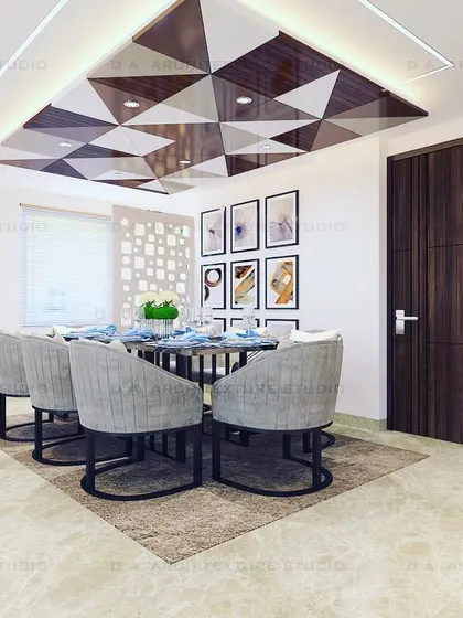 Another angle of the dining area, showing how the geometric ceiling, wall art, and jali partition work together to create a cohesive and modern space.