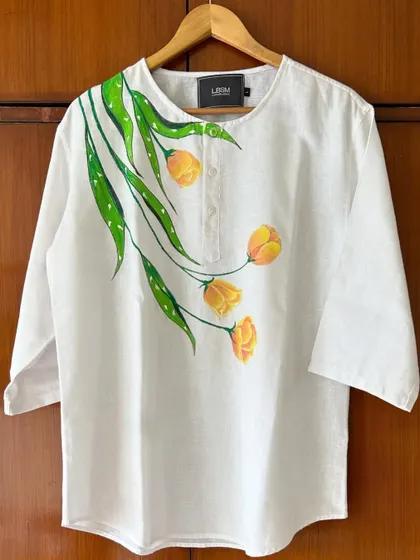 I love turning simple clothing into wearable art. This white linen kurta became a canvas for hand-painted yellow tulips, creating a unique, custom piece of apparel that's perfect for any occasion.