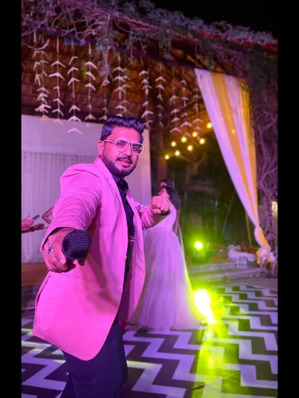 An action pose in a pink blazer, ready to bring the energy.