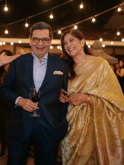The parents of the bride enjoying the reception. She looks absolutely radiant and happy.
